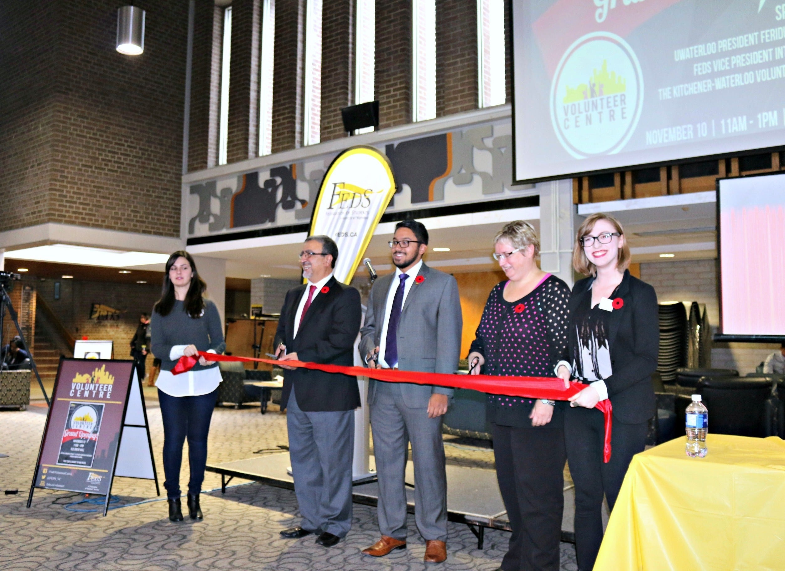 Feridun Hamdullahpur cuts the ribbon with Feds dignitaries at the Volunteer Centre opening.