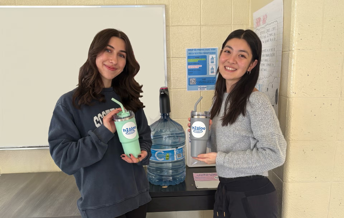 Giordana Staudohar and Isabelle Lee hold water bottles.