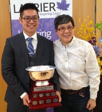 Gah-Jone Won poses with his Three Minute Thesis trophy.