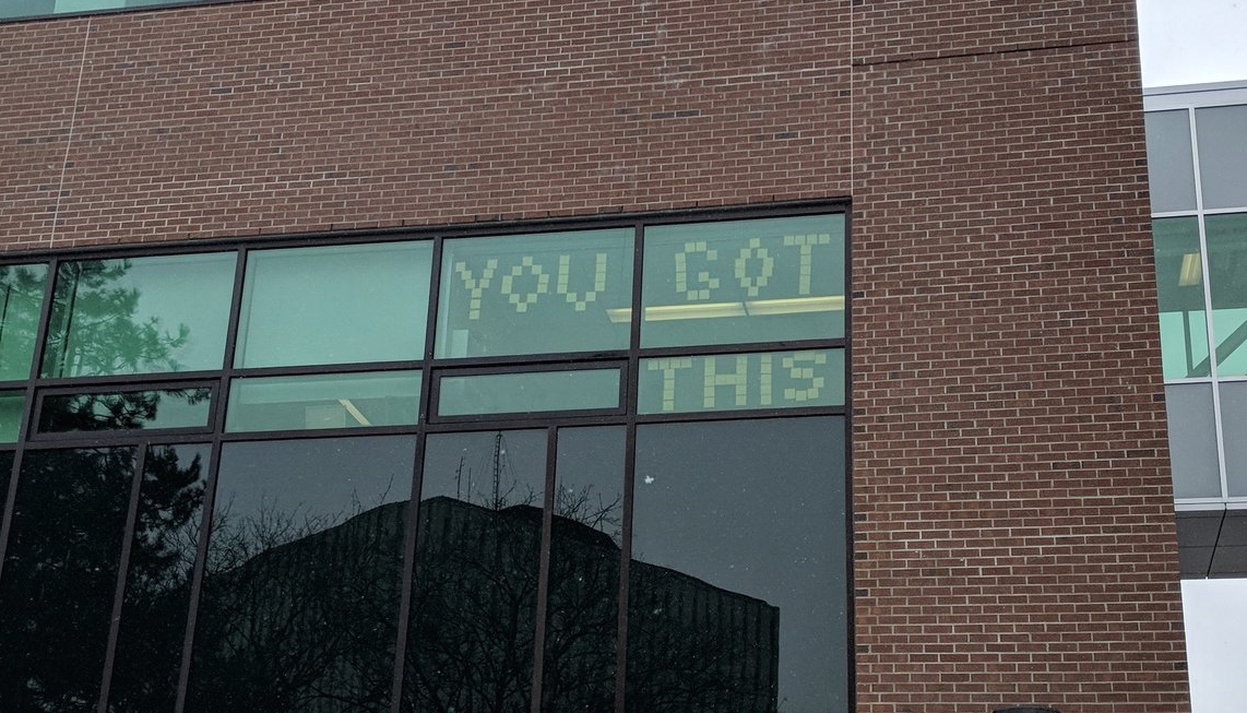 Sticky notes spell out "YOU GOT THIS" in an office window in the Needles Hall expansion.