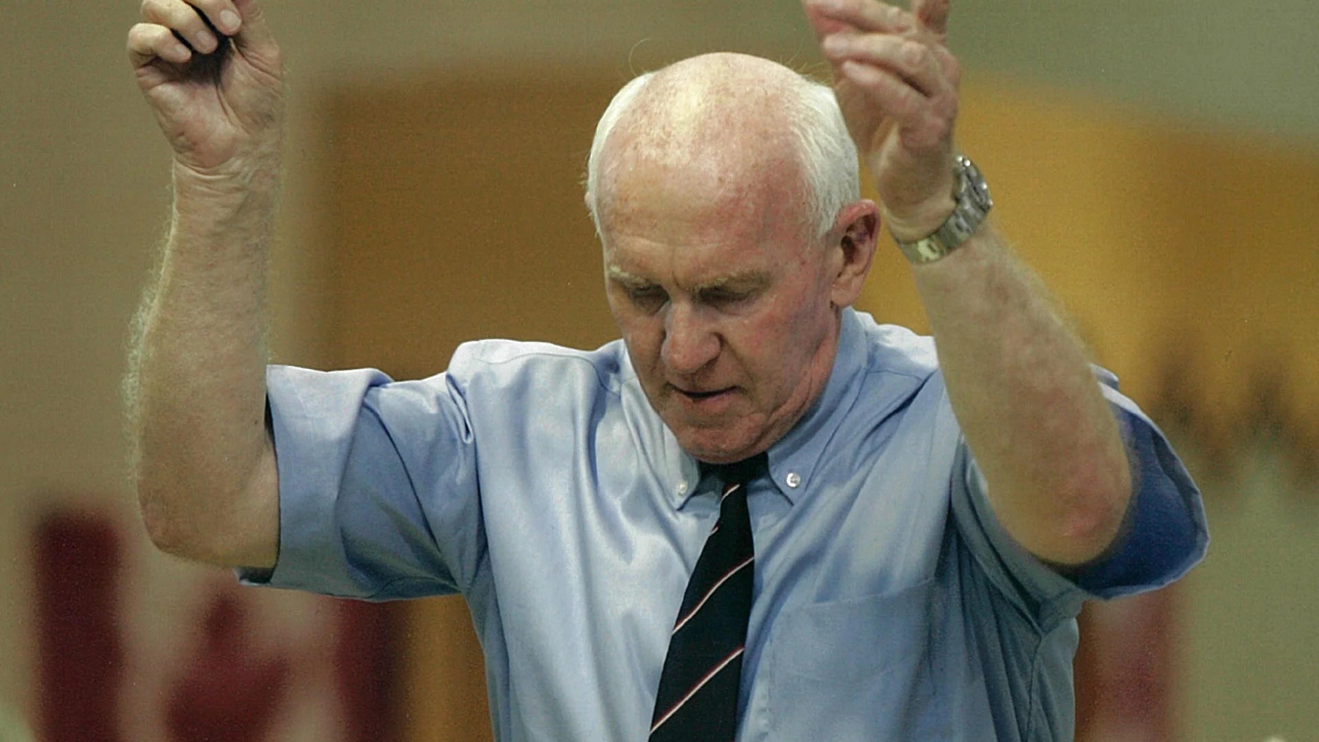 Harry Currie conducts an orchestra.