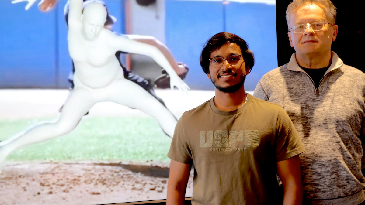 University of Waterloo researchers Jerrin Bright (left) and John Zelek with a screen showing a pitcher behind them.