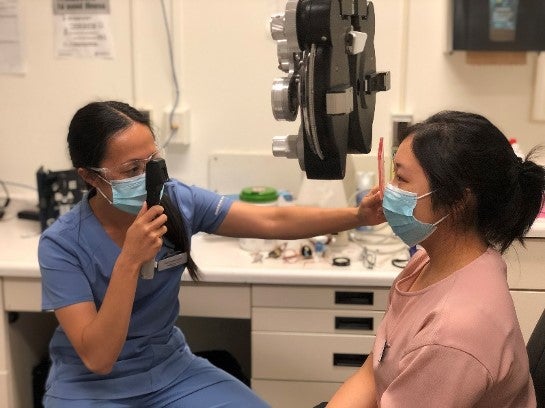 An optometrist conducts an eye exam.