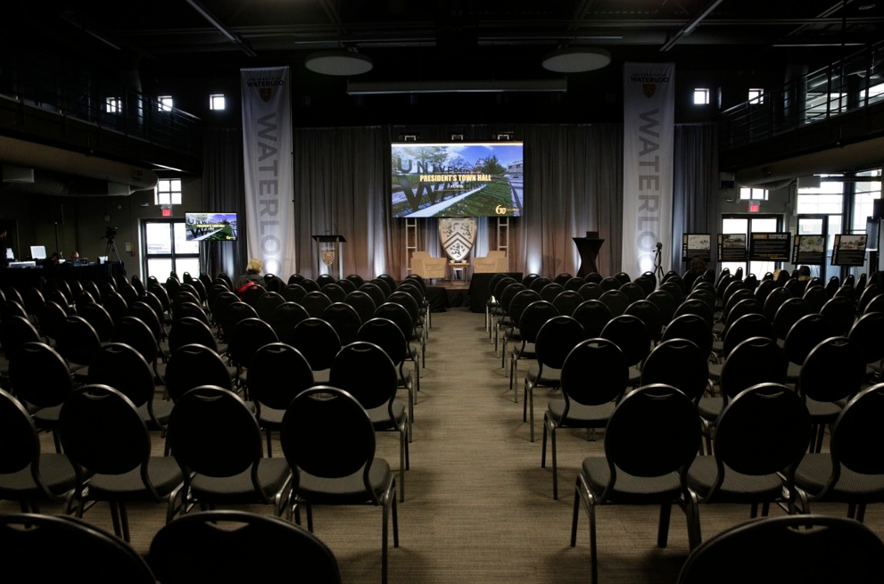 Empty chairs before the town hall stage in Federation Hall.