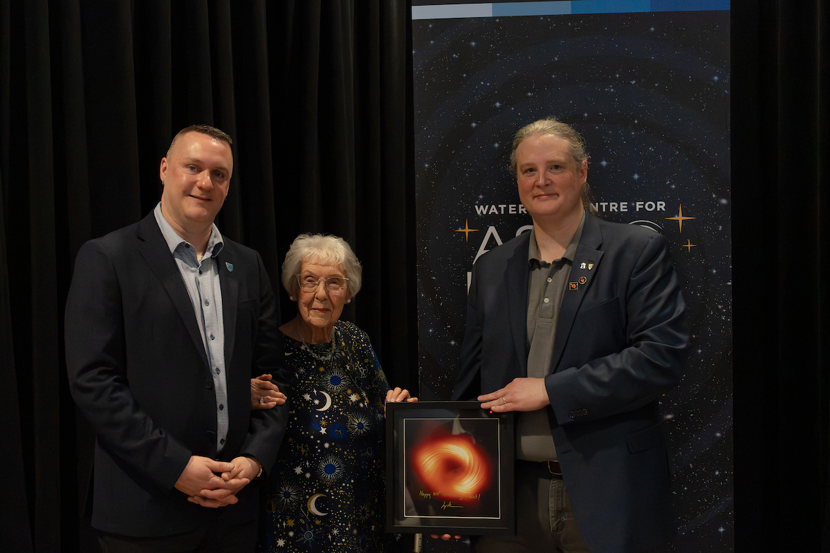 Graham Murphy, Violet Sykes, and Avery Broderick with a signed photograph of Sagittarius A*