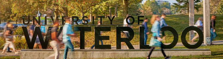 People walk past the University's South Campus Entrance.
