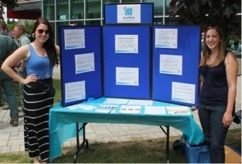 Two women with a display booth.