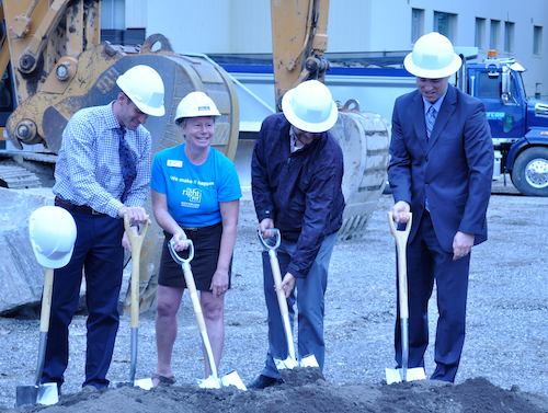 Jennifer Ferguson holds a shovel at the groundbreaking of Claudette Millar Hall.