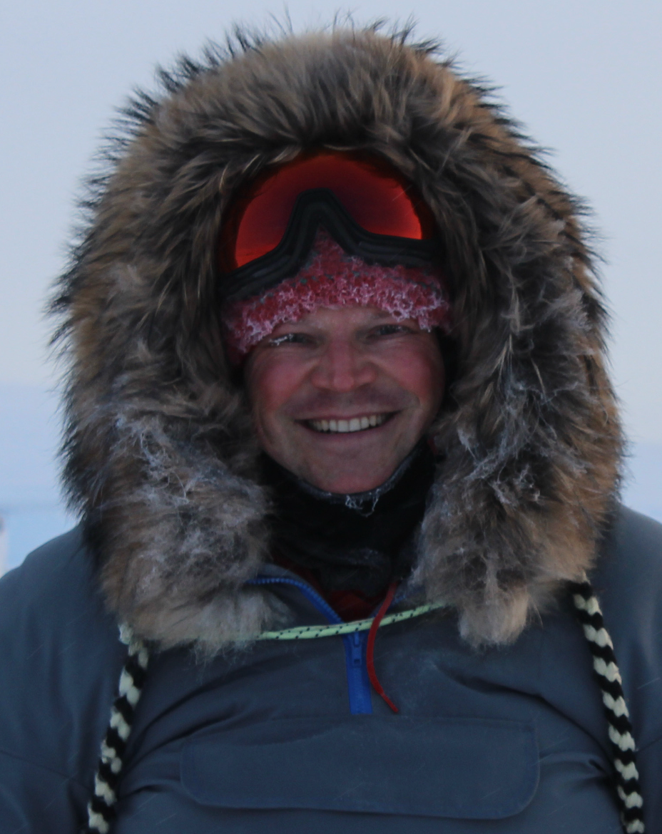 P. Whitney Lackenbauer wearing a parka with furred hood and snow goggles.
