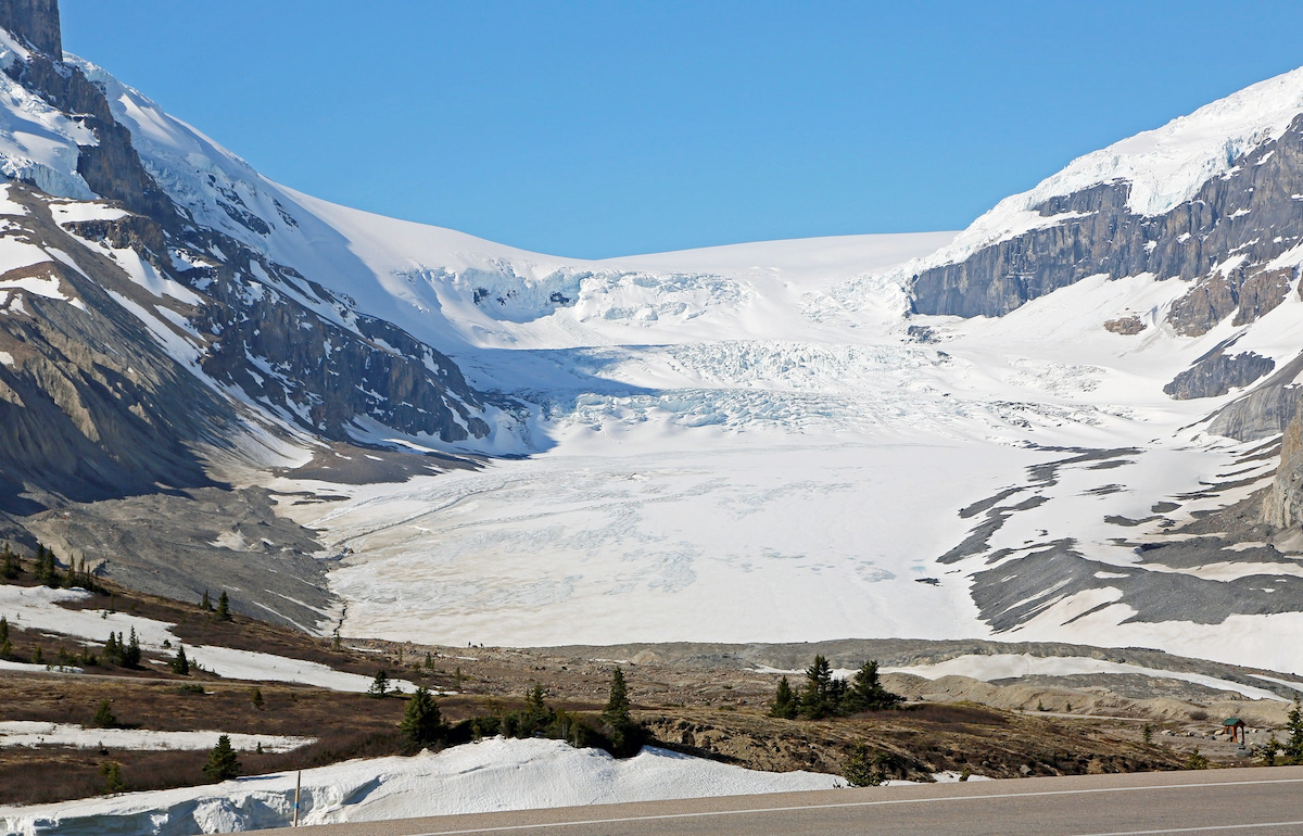 The frozen expanse of the Athabasca glacier framed by mountains.