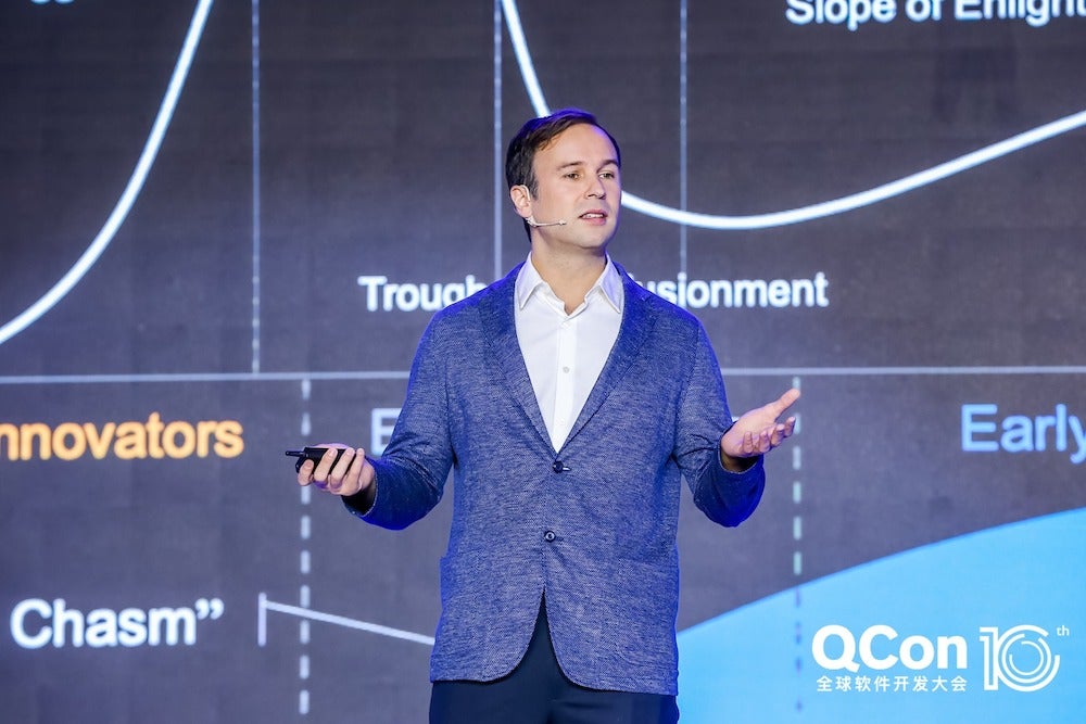 Floyd Marinescu delivers a presentation on a stage.