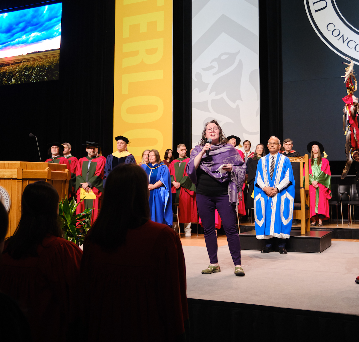 Julie-Ann Desrochers sings the national anthem on the Convocation stage.