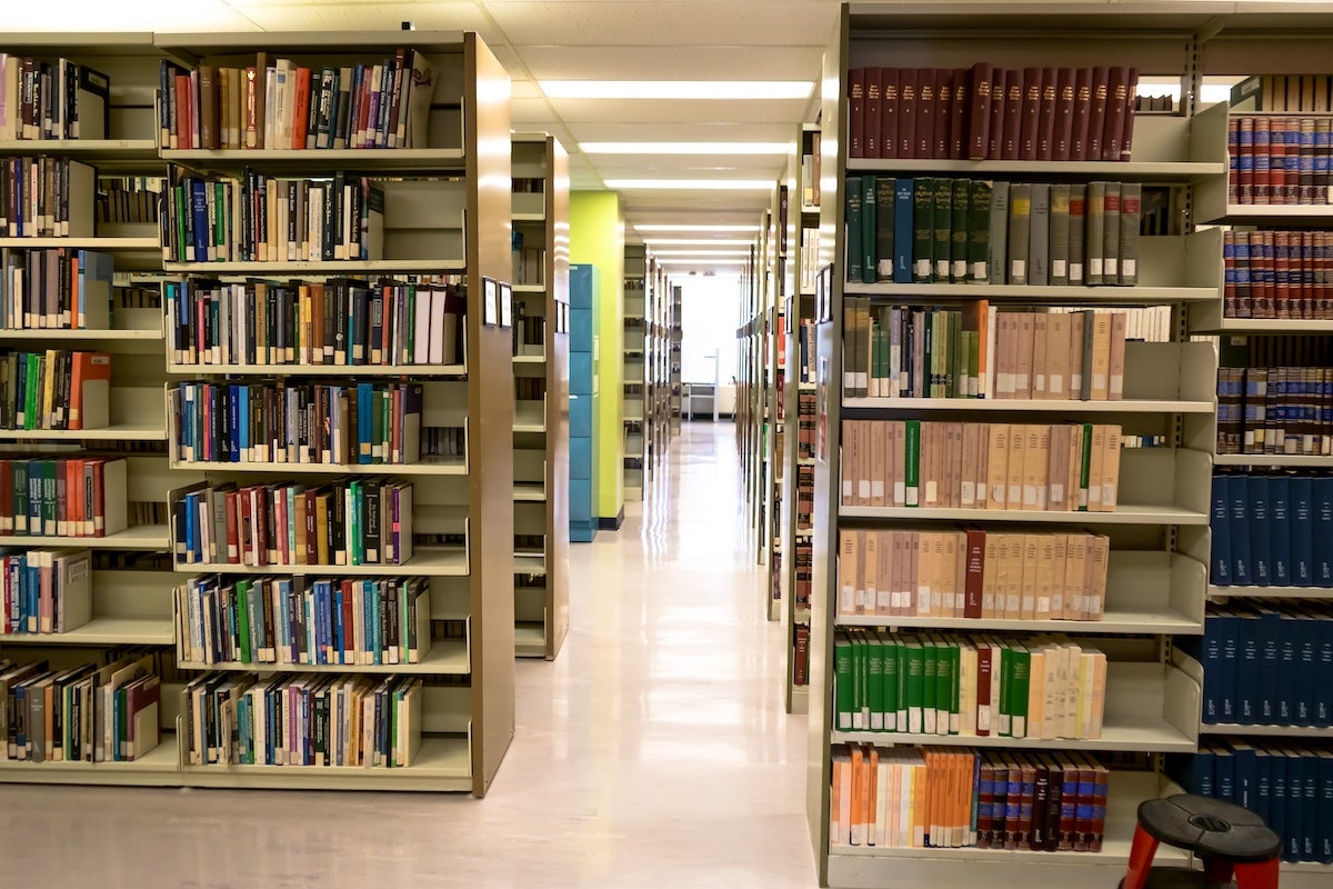 Library stacks - rows upon rows of shelves with books.