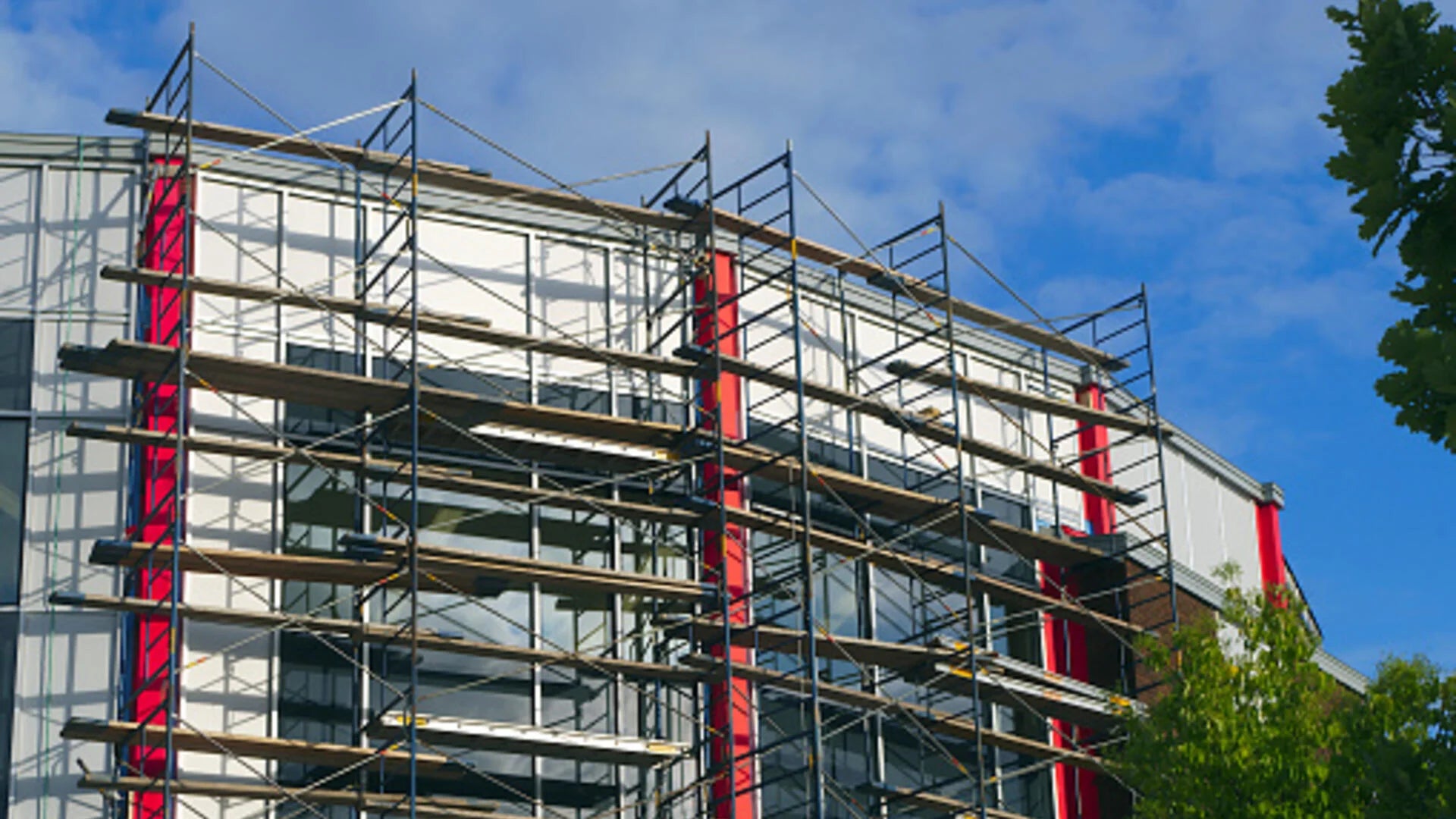 The face of a building covered in scaffolding.