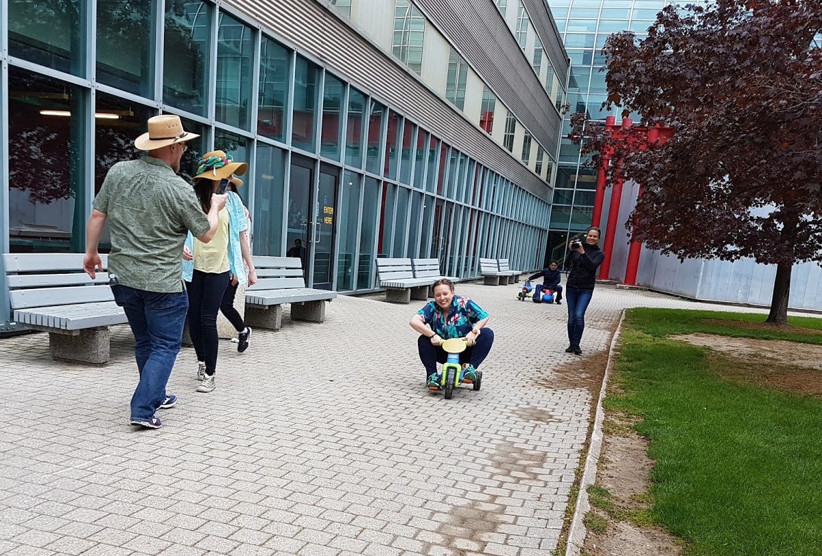 Nat Eibich races a tricycle outside the Davis Centre.