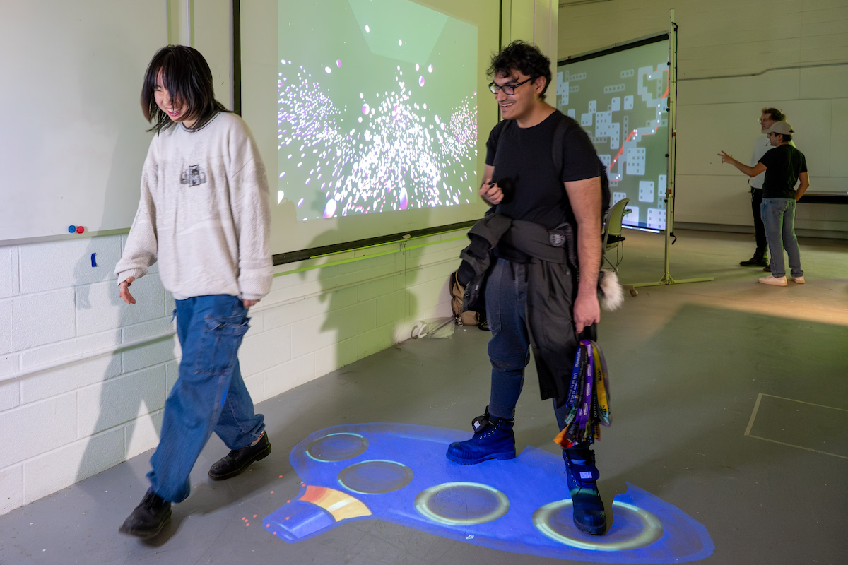 Participants step on the projection-mapped blue ocarina on the floor of ECH.