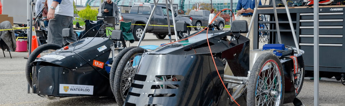 Two electric race cars charging up.