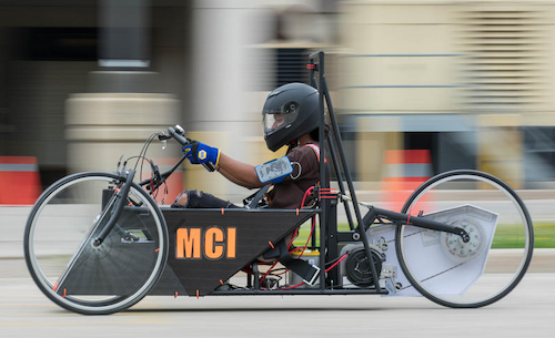 A student drives an electric race car.