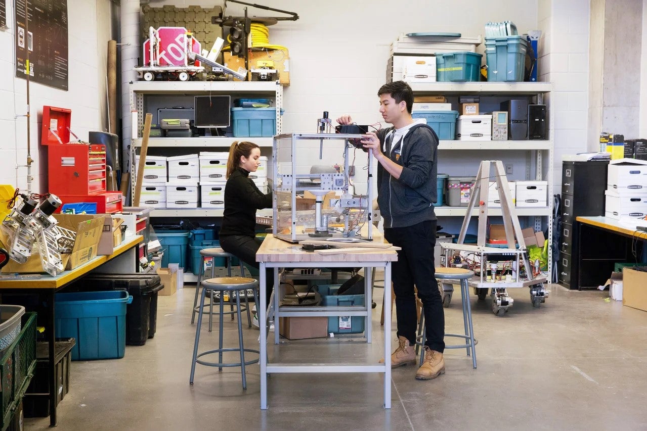 Richard Yim works on a robot.