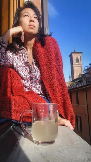 Esmeralda da Conceicao sits in a window in Bologna, Italy.