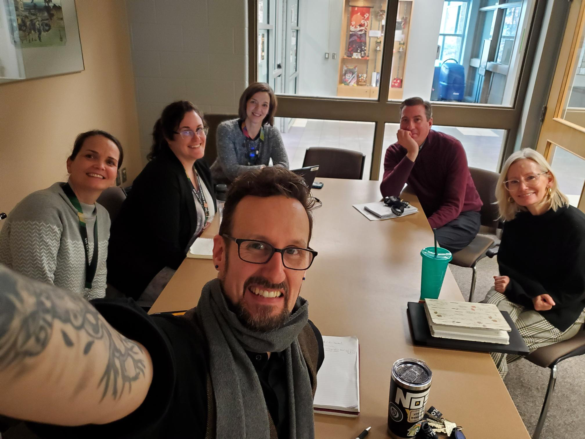 Staff members sit around a conference table.