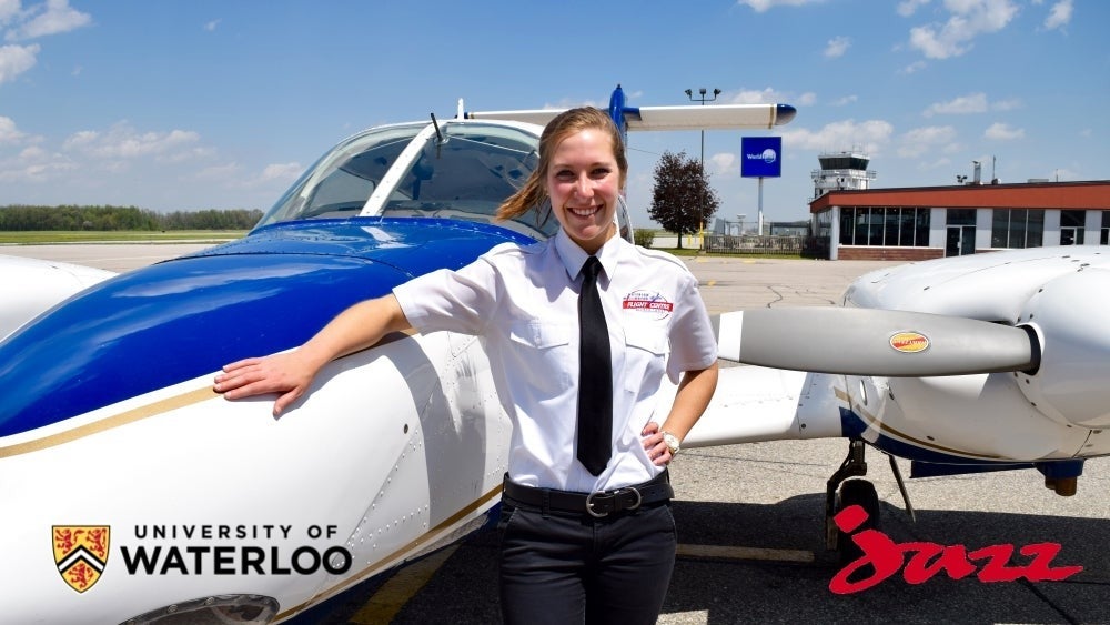 A Flight Centre employee stands next to a small aircraft.