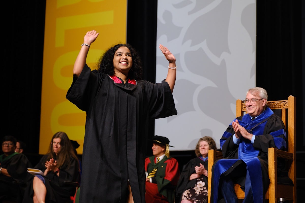 An Engineering student celebrates as she crosses the Convocation stage.