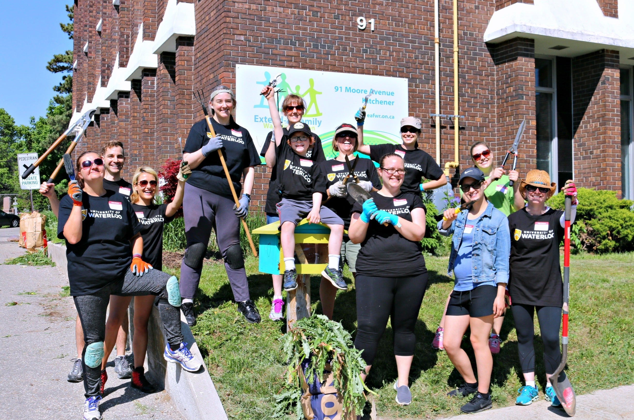 The Waterloo volunteer gardeners outside a building.