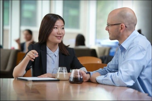 Two people networking in a coffee shop.