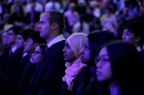 Science graduands stand at Convocation.