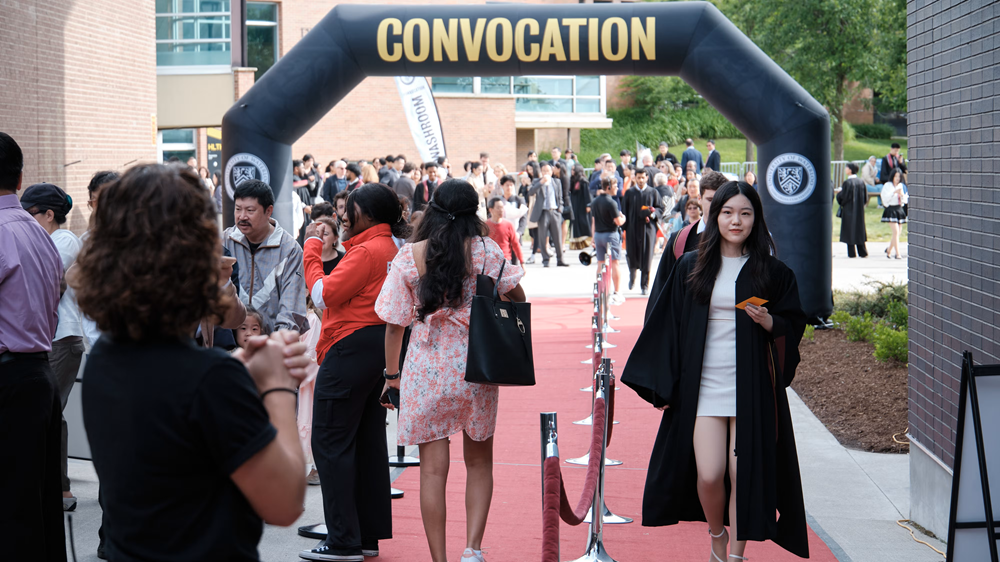 Students cross the official red carpet at Convocation.