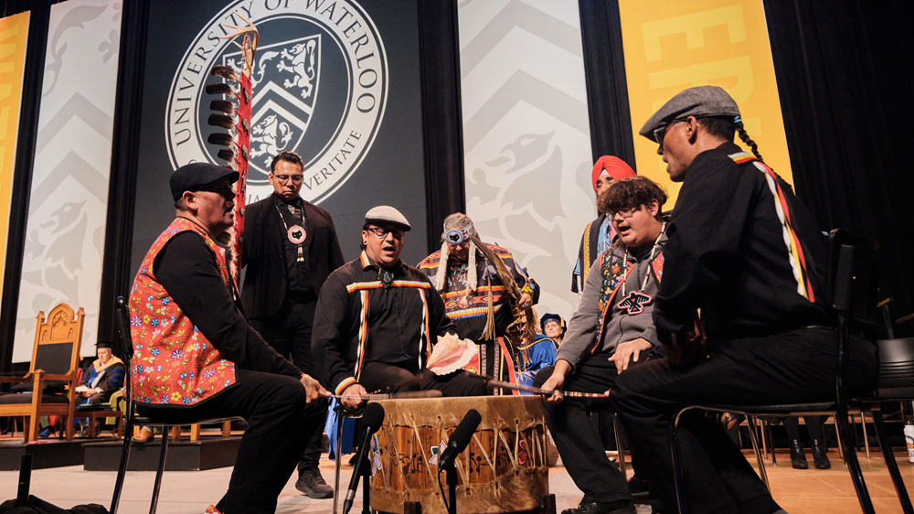 Myeengun Henry leads a drumming group at Convocation.