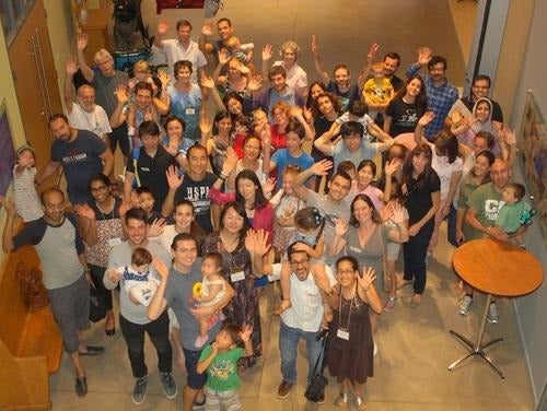 International Spouses group members pose for a photo at a potluck dinner.