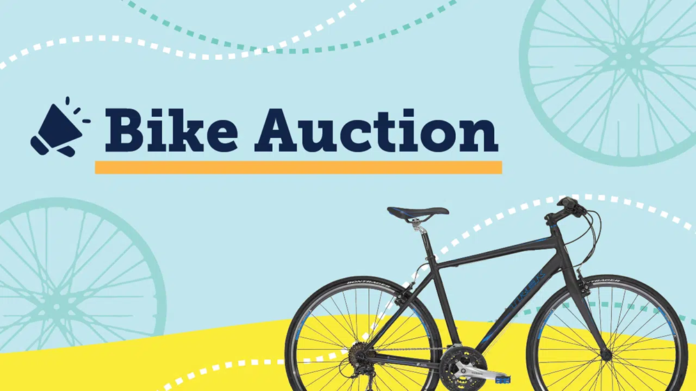 WUSA bike auction banner with a light blue and yellow background, black bike in the corner.