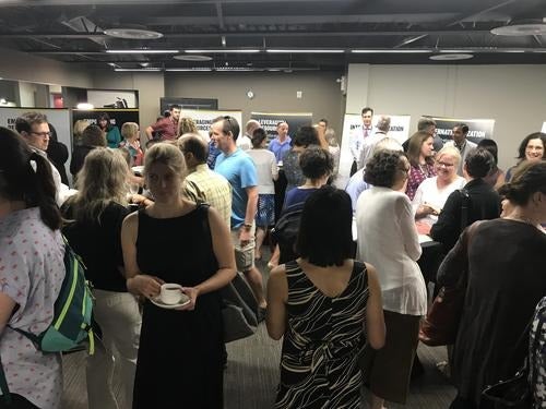 Attendees at the Bridge to 2020 event converse at the breakout consultation stations in Fed Hall.