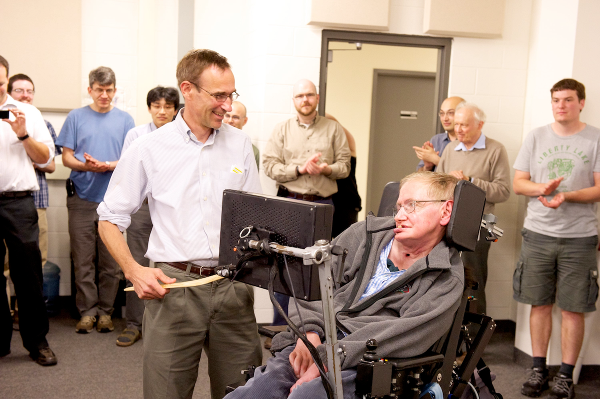 Dr. Ray Laflamme smiles as he receives a boomerang from Dr. Stephen Hawking.