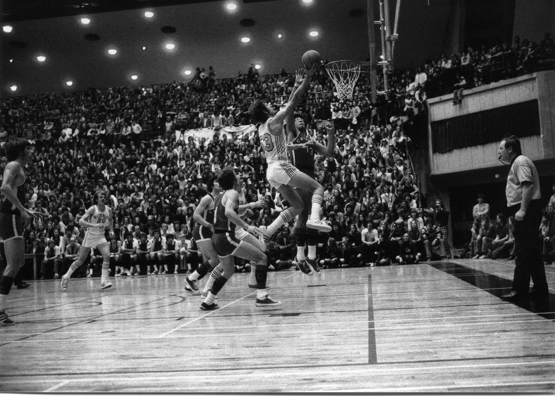 Mike Moser driving for a layup in the University of Waterloo Physical Activities Centre.