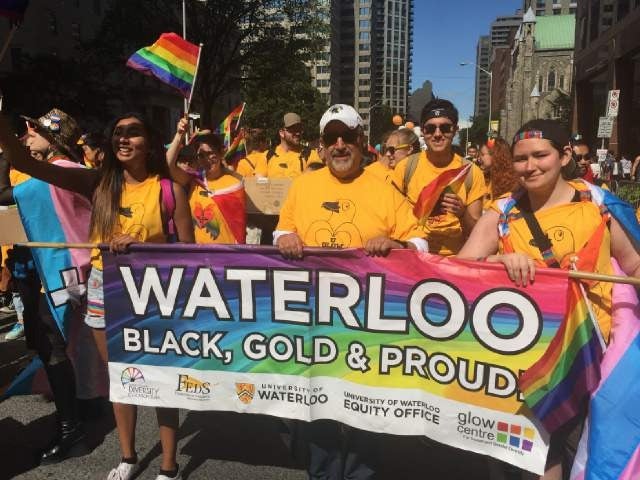 President Feridun Hamdullahpur marches in the Toronto Pride Parade with other Waterloo volunteers.