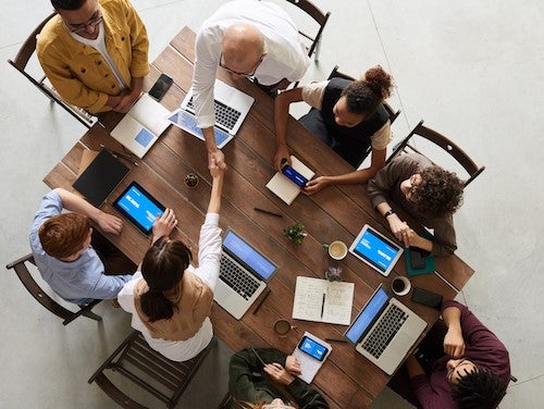 People sit around a conference table.