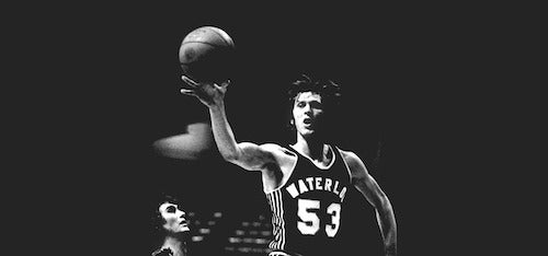 Mike Moser, jersey number 53, catches a pass in mid-air.