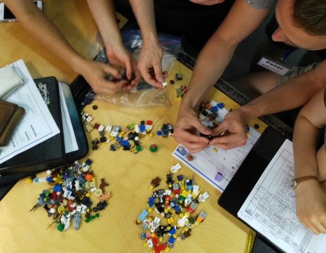 Shad students play with Lego minifigs in a design thinking seminar.