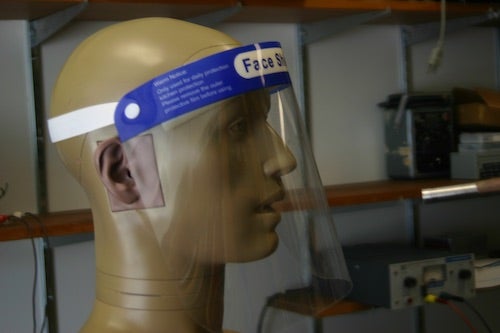 A mannequin head wears a face shield.