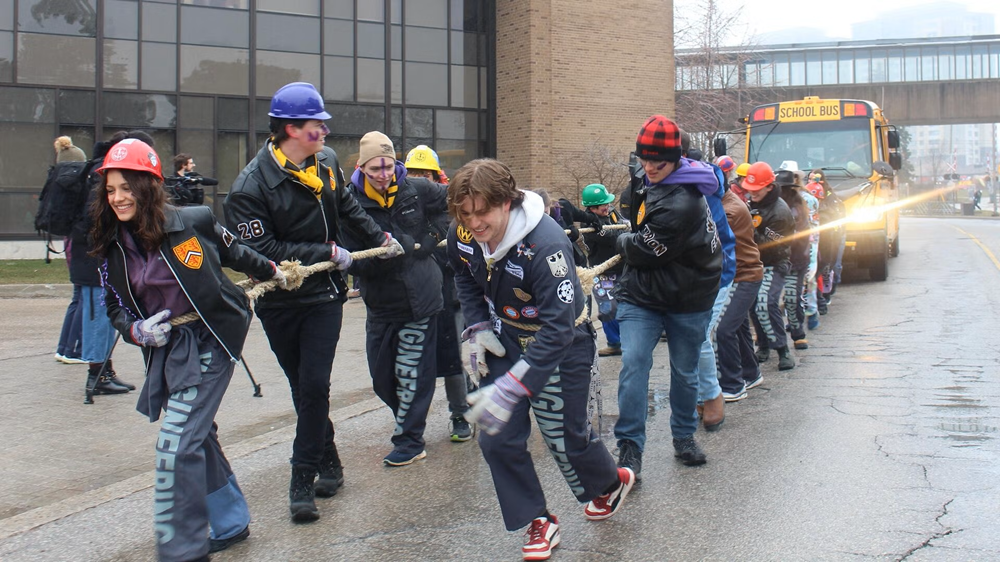 Waterloo students pull a bus down Ring Road.