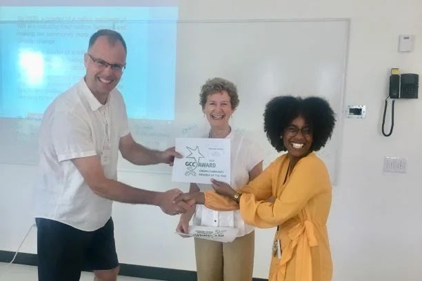 Lecturer Michael Brown smiles as he receives an award certificate.