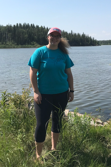 Hannah Thibault standing in wetlands.