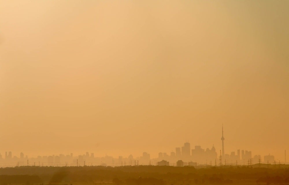 A sky of smoke with the Toronto skyline in the background.