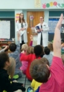 Pharmacy students engage with a class of children.