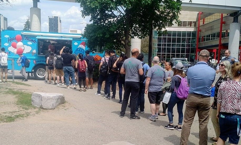 Staff members line up outside the Davis Centre.