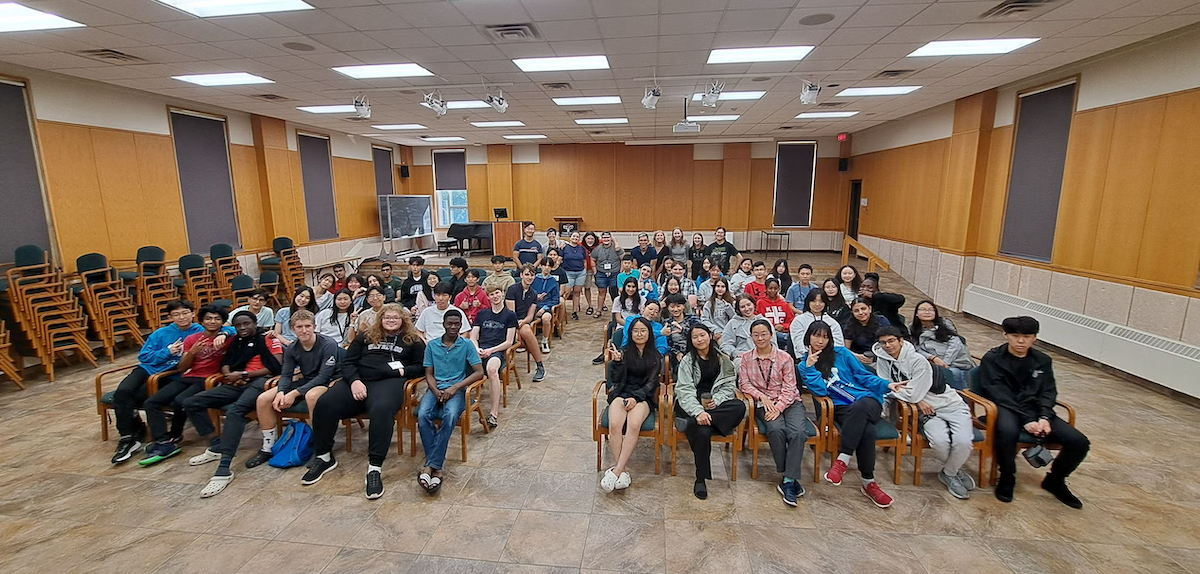 Shad program participants sit in rows of chairs.
