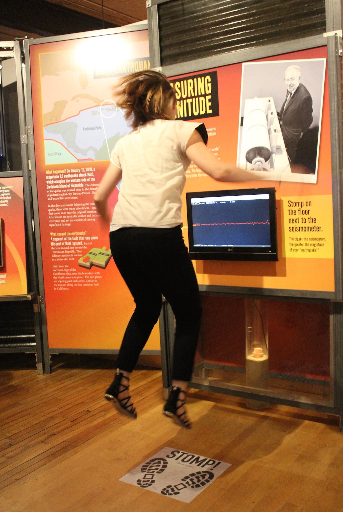 A woman attempts to make a seismic device register through jumping.